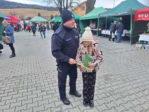 policjanci rozdają odblaski na jarmarku bożonarodzeniowym